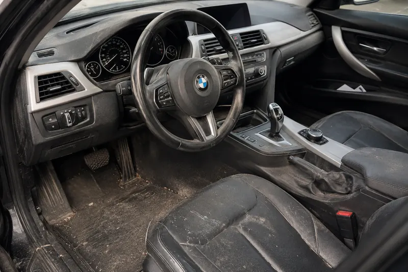 Car interior before detailing: dirty floor and dusty surfaces
